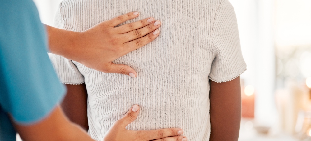 Physician holding patients back, treating back pain