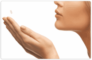 Girl blowing in her hands photo