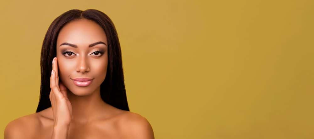 African American girl with beautiful skin and a yellow background