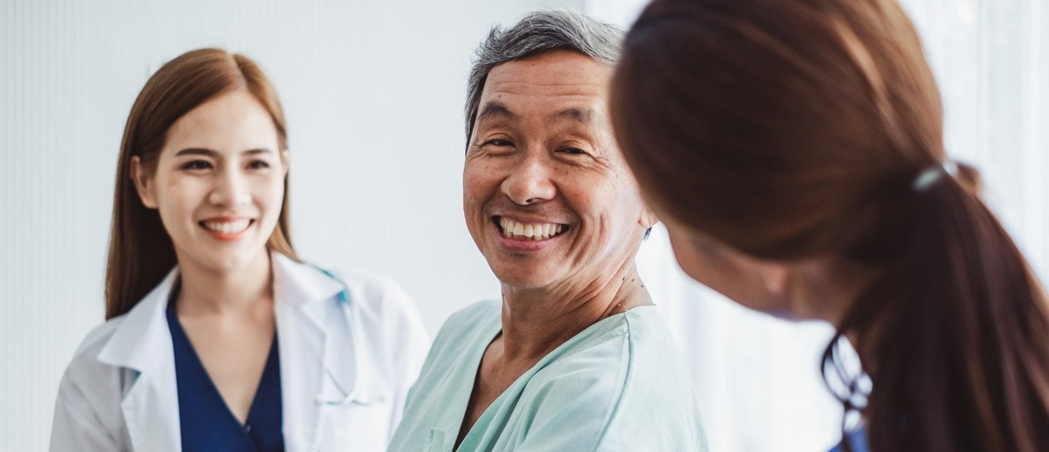 smiling asian patient with nurses