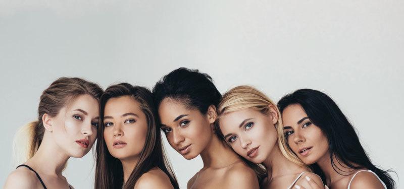 a bunch of beautiful girls with a grey background
