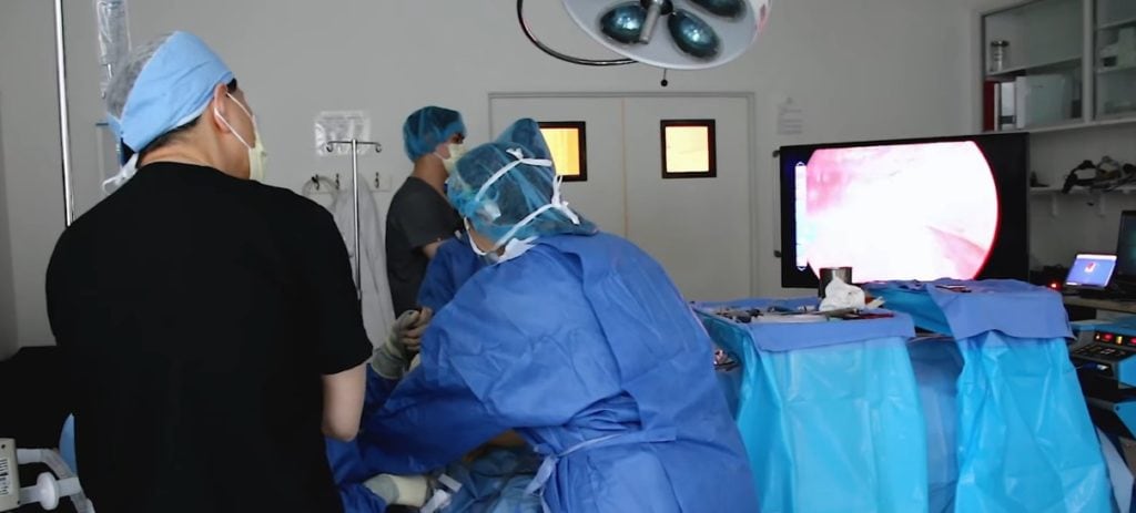 Doctor using endoscope on patient