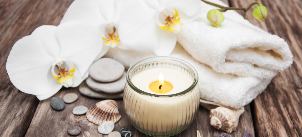 Spa products with white orchids flowers on a table
