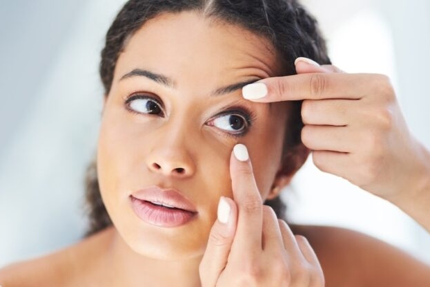 Cropped shot of an attractive young woman considering blepharoplasty and looking at her eyes in the bathroom.