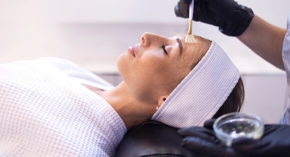 Esthetician applies chemical peel or topical treatment