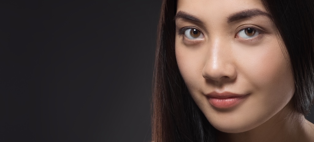 portrait of pretty asian woman with healthy and strong hair isolated on black